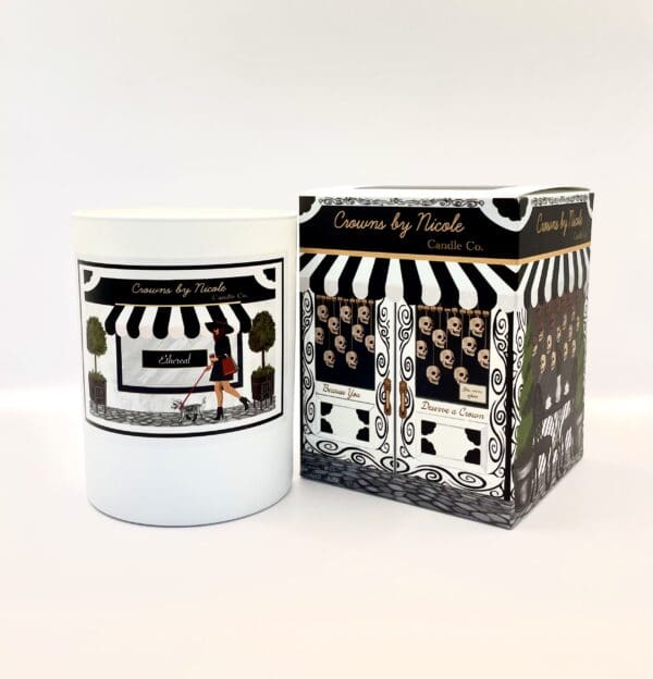 A Saturday Vibes candle in a white container next to its black and white patterned packaging, both labeled "candles by nicole.