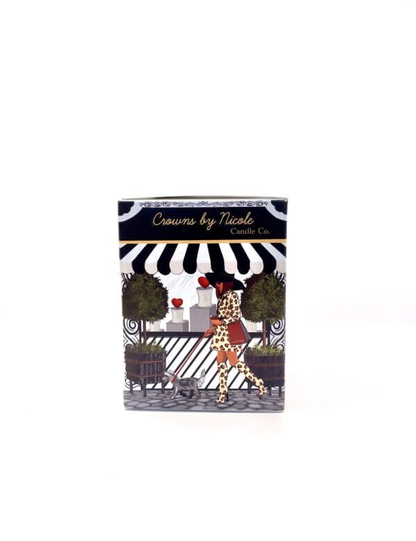 A Ethereal  for My Heart candle with a packaging illustration of a woman walking a giraffe past a cafe under a striped awning.