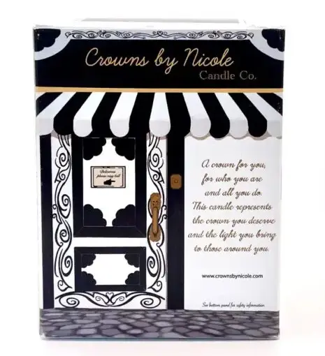 Candle packaging designed to resemble a boutique storefront, labeled "crowns by nicole candle co.," with a decorative awning and an inspirational message.